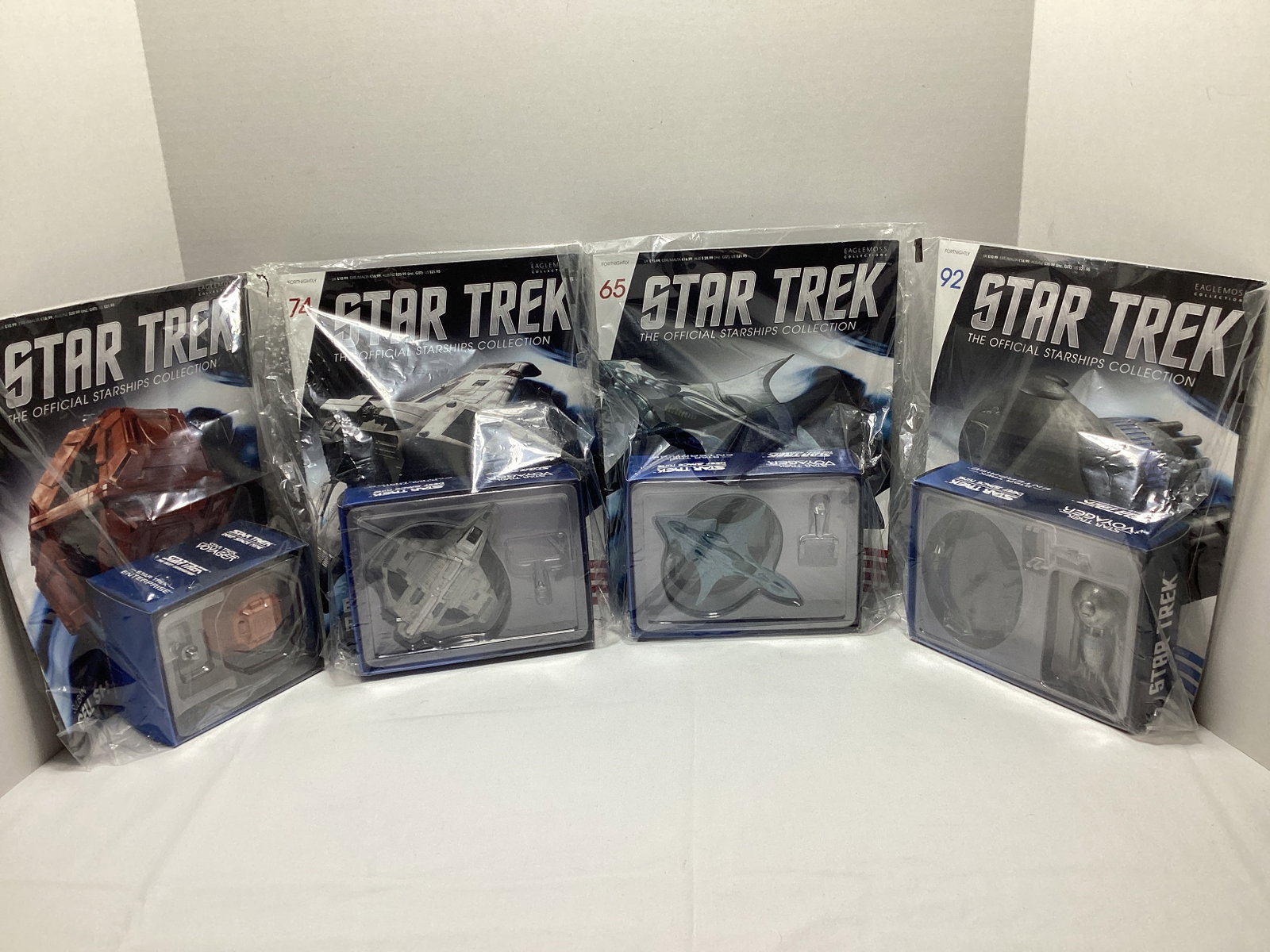 Four Sealed Eaglemoss Star Trek Diecast Starships with Magazines: some bags ripped, Medusan Ship, Xindi-Aquatic Cruiser, Bajoran Raider, Suliban Cell Ship