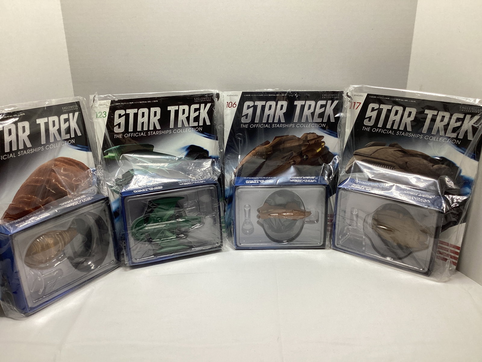 Four Sealed Eaglemoss Star Trek Diecast Starships with Magazines: some bags ripped, Kazon Raider (bag open at top), Romulan Science Vessel, 22nd Century Ferengi Starship, Gomtuu
