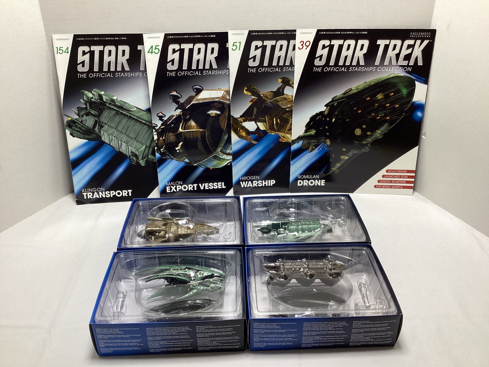 Four Eaglemoss Star Trek Diecast Starships with Magazines: appears new in box, Romulan Drone, Hirogen Warship, Malon Export Vessel, Klingon Transport