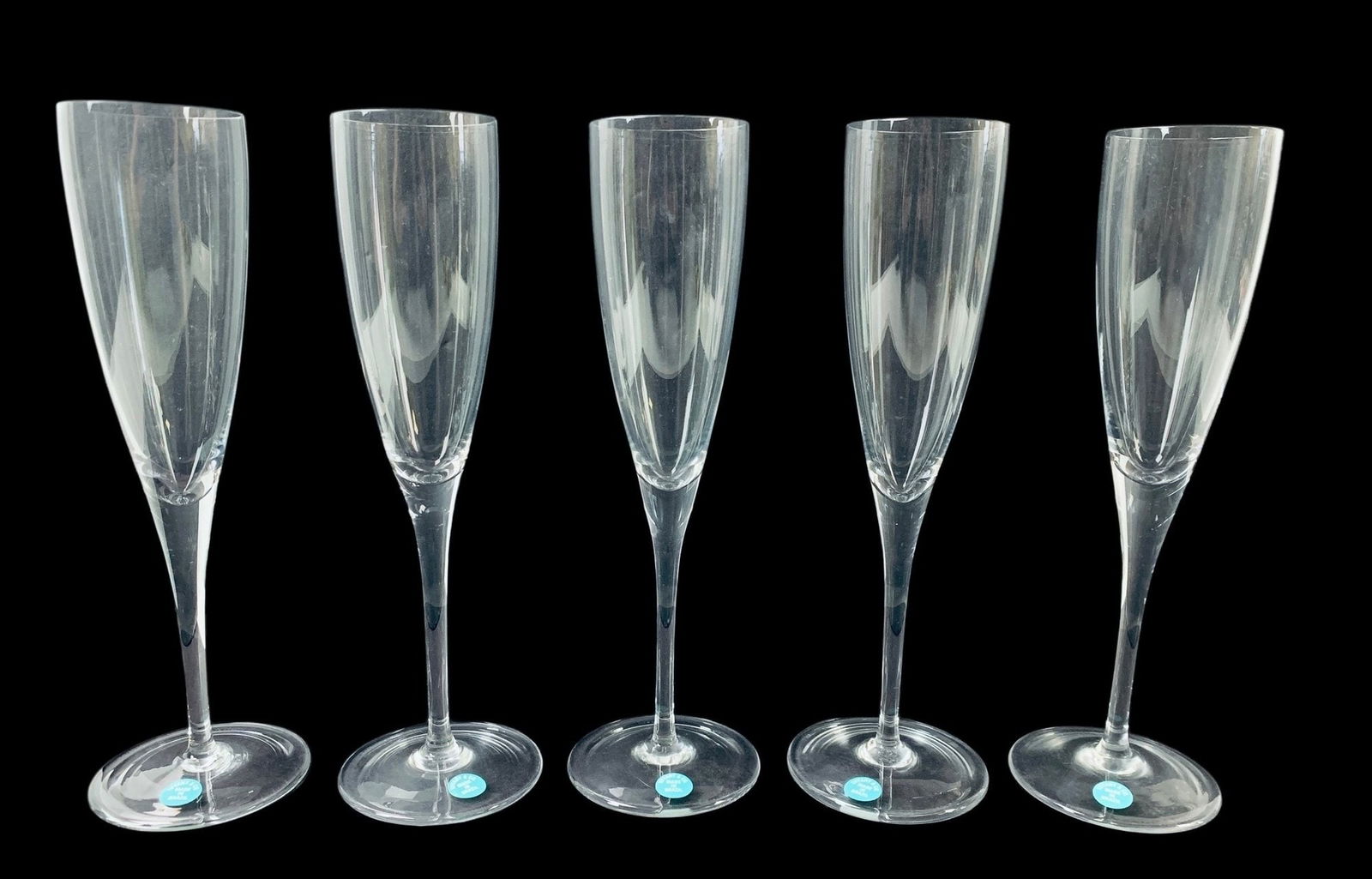 Tiffany & Co. Crystal Champagne Flutes (Set Of 5) - #S17-3: New old stock. Tiffany hallmark etched on the underside of each glass, with original Tiffany blue label affixed to the foot. Height: 9-1/4 inches LOCAL PICK-UP: SATURDAY, FEBRUARY 21ST FROM 11AM-3PM.