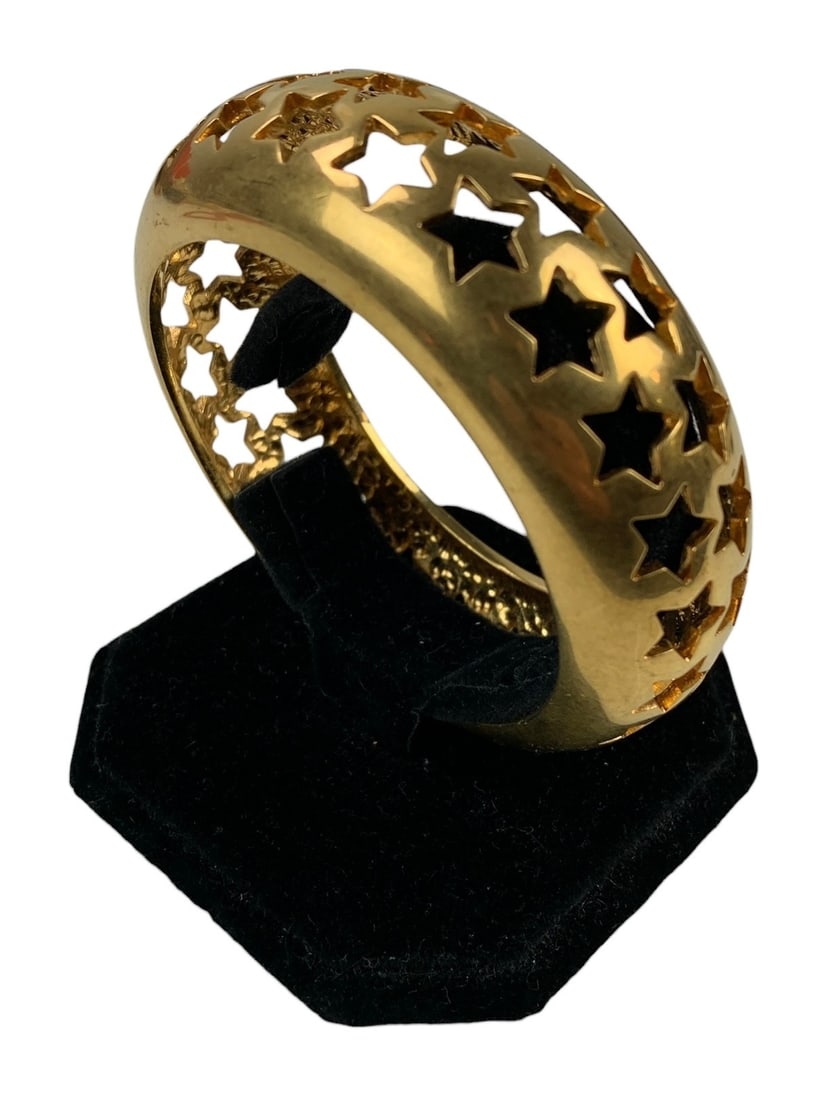 Saint Laurent Paris Gold Tone Star Bangle Bracelet - #S18-3: Stamped "Saint Laurent Paris" on one side. Condition: scuffs/scratches consistent with normal wear. Measurements: Width: 1-1/8" x Exterior Diameter: 10.5" x Interior Diameter: 7.75" LOCAL PICK-UP: SAT