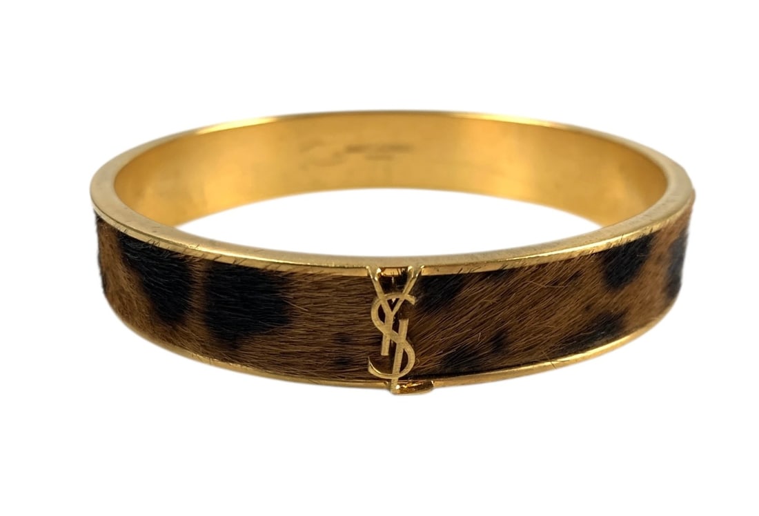 Yves Saint Laurent Paris Gold Tone Logo Genuine Fur Bangle Bracelet - #S18-3: Stamped "Saint Laurent Paris" on the interior. Inner diameter: 2.5 inches. LOCAL PICK-UP: SATURDAY, FEBRUARY 21ST FROM 11AM-3PM. LOCATION: 35 MECHANIC STREET, AMENIA, NY 12501 INVOICES MUST BE PAID PR