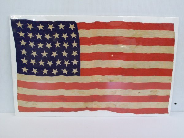 Flag: 39 star flag. Some staining. 24 inches wide x 14 1/2 inches high
