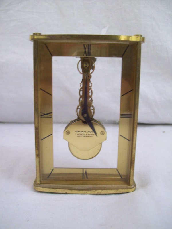 CLOCK: HAMILTON JEWELS 8 DAY W. GERMANY CARRIAGE CLOCK. 4 INCHES HIGH X 2 1/2 INCHES WIDE