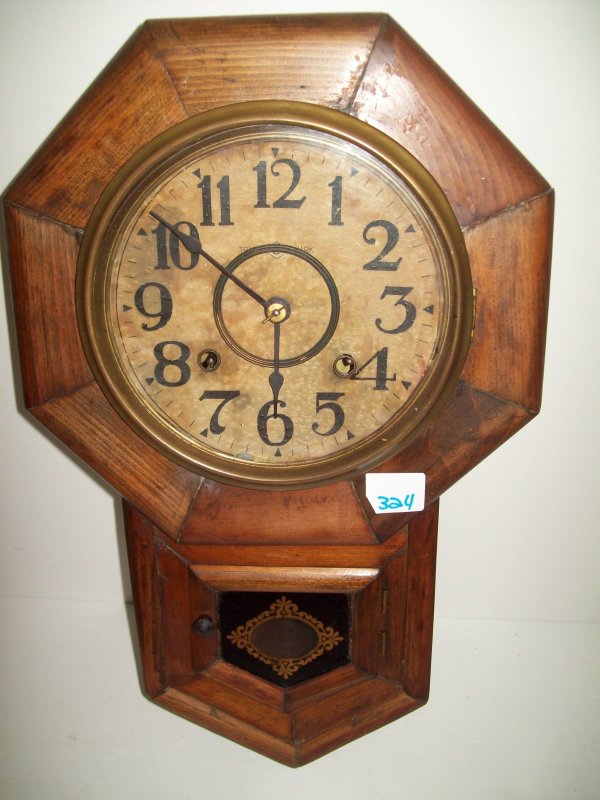 SEGOOSHA CLOCK: SEGOOSHA WALL CLOCK. WEAR; FACE STAINES; TEAR. 19 INCHES HIGH X 12 INCHES WIDE
