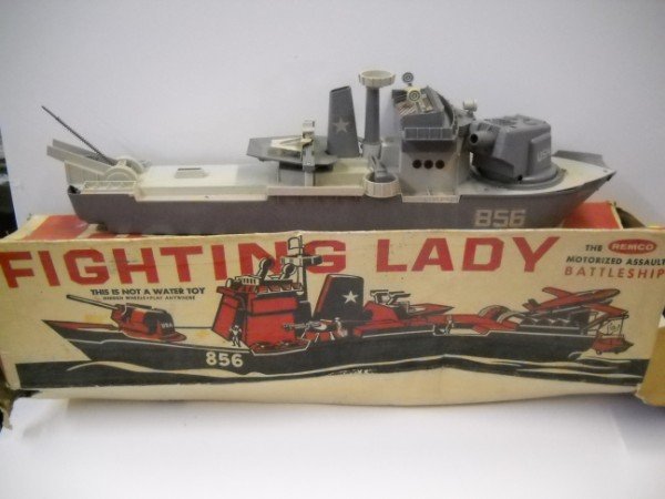 TOY: FIGHTING LADY BATTLESHIP BY REMCO. BOW OF SHIP CRACKED, NO ACCESSORIES. BOX STAINED; TORN. 32 INCHES WIDE X 9 INCHES HIGH
