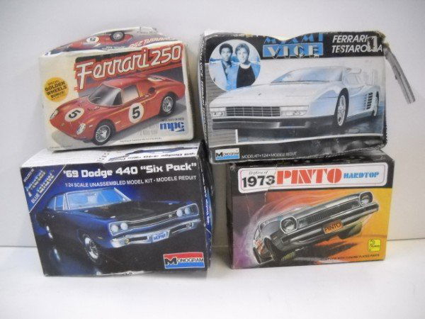 MODEL KIT: 4 MODEL CAR KITS. BOX TORN; USED CONDITION.