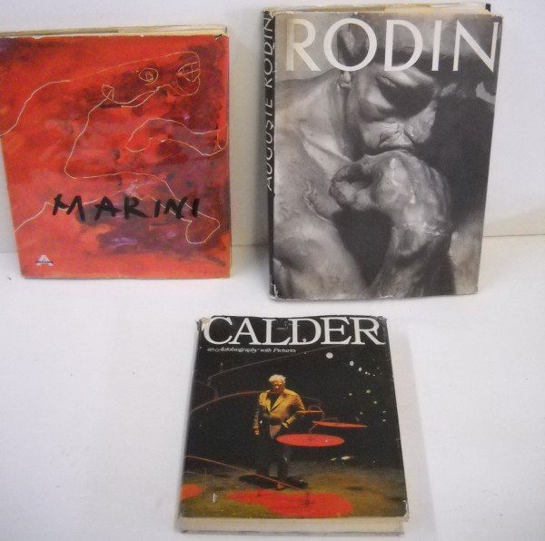 BOOKS: 3 ARTISTS BOOKS INCLUDING AUGUSTE RODIN 1939; MARINI 1957; CALDER AN AUTOBIOGRAPHY WITH PICTURES. COVERS HAVE STAINING; TEARS. LARGEST MEASURES 14 INCHES X 10 1/2 INCHES