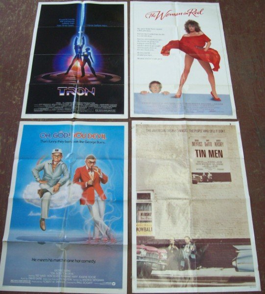 POSTERS: 4 POSTERS INCLUDING TRON; OH GOD YOU DEVIL; THE WOMAN IN RED; TIN MAN. FOLDED CREASES; USED CONDITION; TEARS; FOXING. 41 INCHES X 47 INCHES