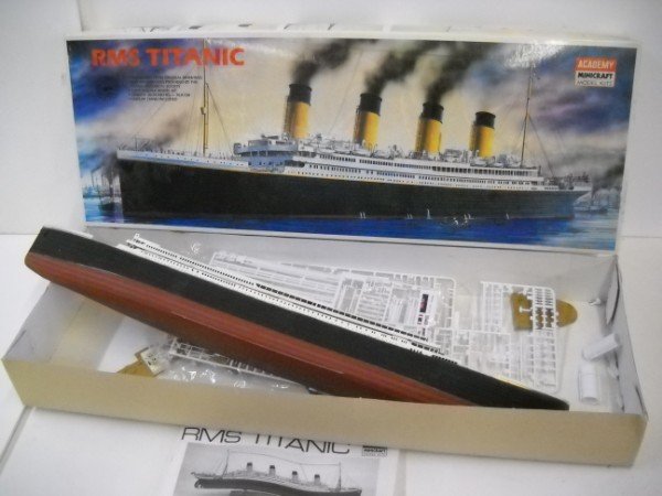 MODEL KITS: RMS TITANIC MODEL BY ACADEMY MINI CRAFT MODEL KIT MADE IN KOREA. PARTIALLY BUILT. STAINS; USED CONDITION. 31 INCHES X 11 INCHES X 4 INCHES