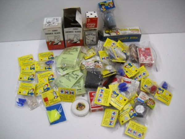 GAG/NOVELTY TOYS: GAS TOYS INCLUDING DRIBBLE GLASS; MYSTIFYING PYRAMID PUZZLE. SOME IN ORIGINAL PACKAGES. USED CONDITION. LARGEST MEASURES 6 INCHES