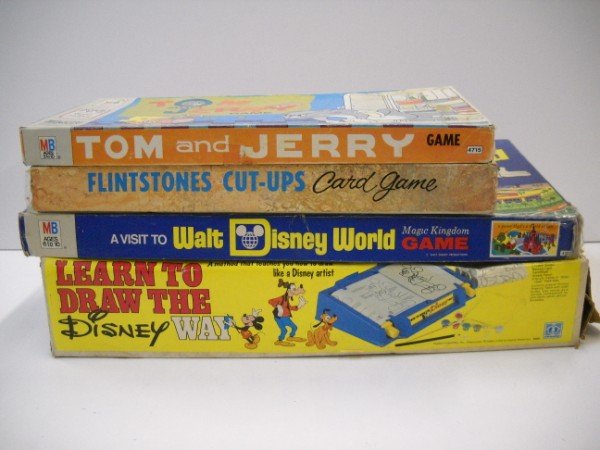 BOARD GAMES: VARIOUS GAMES INCLUDING LEARN TO DRAW THE DISNEY WAY; WALT DISNEY WORLD GAME; TOM & JERRY; FLITSTONES CUT UP CARD GAME. BOXES TORN; PEALING; WEAR; USED CONDITION. LARGEST MEASURES 19 INCHES X 8 INCHES