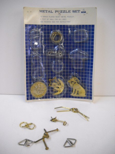 TOYS: METAL PUZZLE SET WITH ORIGINAL PACKAGE BY SPENCER GIFTS. PACKAGE OPENED. 11 INCHES X 8 1/2 INCHES