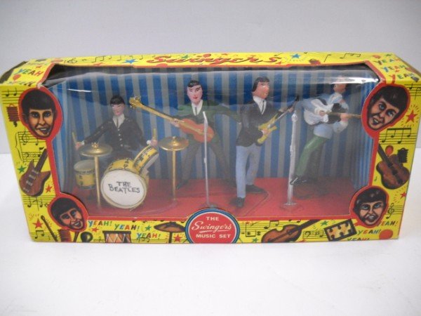 TOY: THE SWINGERS MUSIC SET IN ORIGINAL PACKAGE OPENED, THE BEATLES NAME ON DRUMS ADDED NOT ORIGINAL TO TOY. (VINTAGE KNOCK OFF OF THE BEATLES) FROM HONG KONG. 9 1/2 INCHES X 5 INCHES X 2 1/2 INCHES. CALL