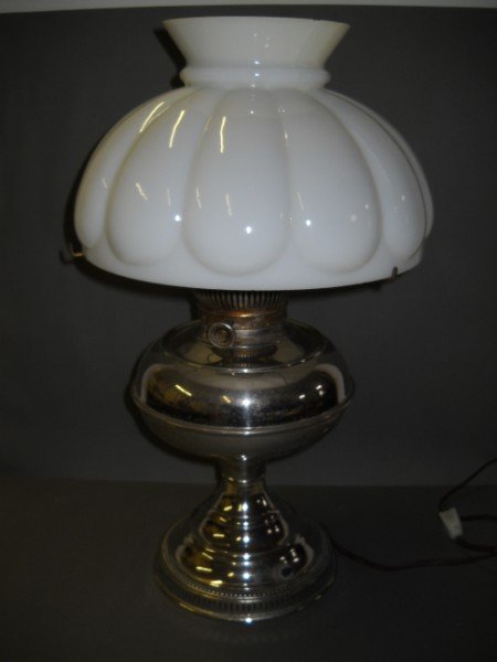 LIGHTING: RAYO LAMP WITH MILK GLASS SHADE. SHADE CHIPS TO RIM. 18 INCHES HIGH X 9 INCHES WIDE WITH SHADE. CALL 845-457-7550 OR EMAIL STERLINGAUCTION@AOL.COM FOR FULL CONDITION REPORT, SHIPPING/PACKING QUOTES PR