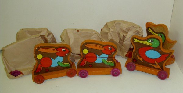 PULL TOYS: 8 PULL TOYS BY GENUINE KITS TIMBER TOY. SOME STILL IN ORIGINAL WRAPING. LACKING WHEEL, TEARS; CALL 845-457-7550 OR EMAIL STERLINGAUCTION@AOL.COM FOR FPAPER PEELING OFF; CHIPS. 7 INCHES HIGH X 8 INCHES