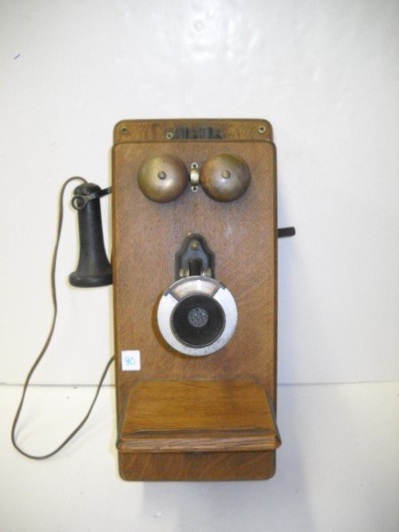 WALL HANGING PHONE: STROMBERG CARLSON TELEPHONE MFG. CO. WALL HANGING WOOD PHONE. 22 INCHES X 9 INCHES.