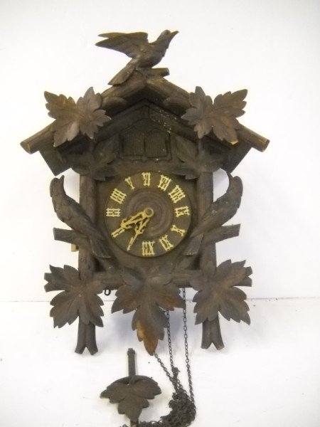 CUCKOO CLOCK: CUCKOO CLOCK. CHIPS; USED CONDITION. 1 WEIGHT. 16 INCHES X 13 INCHES.
