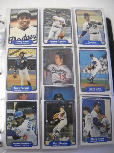 SPORTS CARDS: COLLECTION OF VARIOUS SPORTS CARDS INCLUDING BASEBALL- DUSTY BAKER; STEVE HOWE; JEFF JONES; CECIL COPPER. APPROX 74 PAGES.