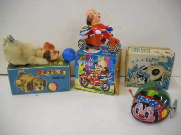 WIND UP TOYS: 3 WIND UP TOYS INCLUDING LADY BUG; CLOWN ON TRICYCLE; DOG WITH BALL. IN ORIGINAL BOXES. WEAR; USED CONDITION; STAINS.