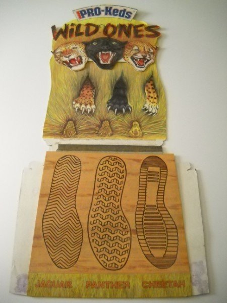 ADVERTISING DISPLAY: PRO KEDS WILD ONES ADVERTISING CARDBOARD STORE DISPLAY WITH DIRECTIONS. MADE IN U.S.A. USED CONDITION; STAINS; PAPER PEELING; PAPER LOSS; RUST FROM STAPLES. 24 1/2 INCHES HIGH X 14 1/2 INCHES WIDE.