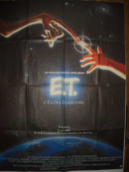 MOVIE POSTER: 1982 L' EXTRA-TERRESTRE (E.T.) FRENCH MOVIE POSTER SIGNED IN PLATE ALVIN, WITH DEE WALLACE, PETER COYOTE, HENRY THOMAS. USED CONDITION; WRITING ON BACK; FOLED CREASES; SMALL TEARS AT FOLDS. 62 INCHES