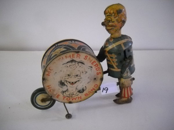 TIN TOY: MORTIMER SNERD'S HOME TOWN BAND TIN WIND UP TOY BY MARX. PAINT LOSS; SCRATCHES; RUST. 8 INCHES X 9 INCHES