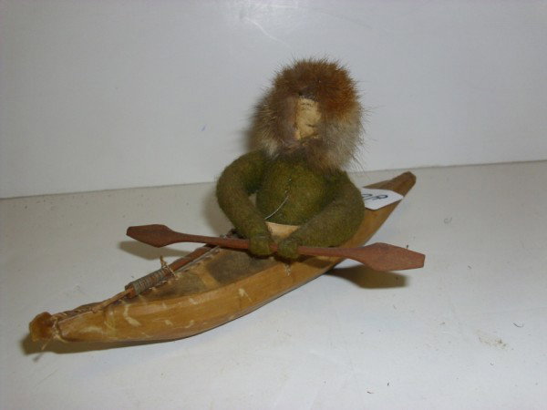 INUET MAN IN CANOE: INUET MAN IN CANOE TOY. 8 1/2 INCHES