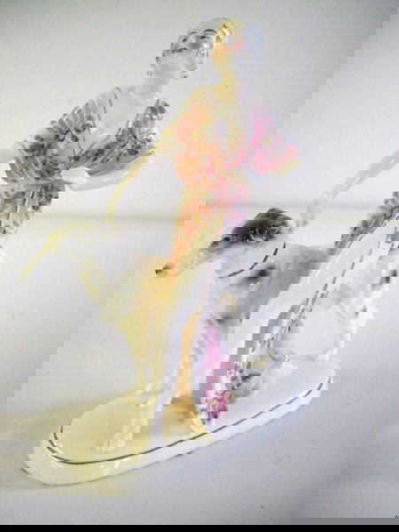 CERAMIC STATUE: GIRL WITH DOG CERAMIC STATUE MARKED ON BOTTOM. 9 INCHES X 5 INCHES