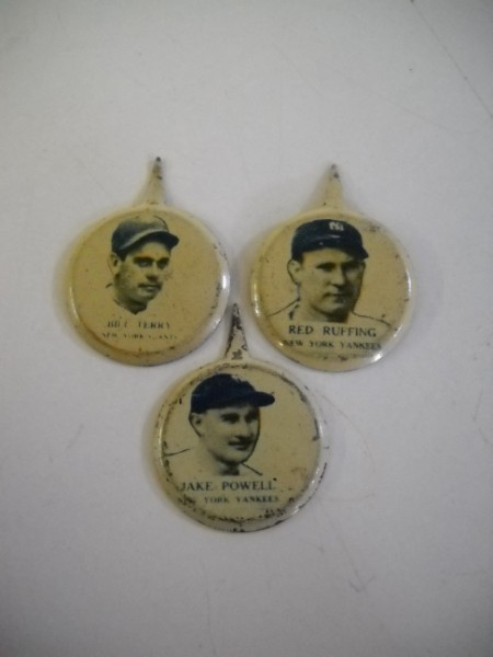 BASEBALL PINS: 3 BASEBALL PINS INCLUDING JAKE POWELL; RED RUFFING. SCRATCHES; WEAR; USED CONDITION.