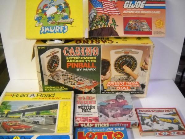 TOYS: COLLECTION OF VARIOUS TOYS INCLUDING CASINO PINBALL BY MARX; BUILD A ROAD; GI JOE BOARD GAME; SMURFS RECORD PLAYER. USED CONDITION, TEARS; STAINES; SMURFS IN RUFF CONDITION.