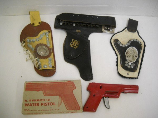TOY GUN HOLSTERS: 3 TOY GUN HOLSTERS; & NO 18 WYANDOTTE TOY WATER PISTOL WITH ORIGINAL BOX. STAINED; OXIDATION. 11 INCHES X 5 INCHES.