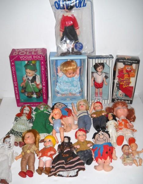 DOLLS: COLLECTION OF ASSORTED DOLLS INCLUDING OLIVE OIL; FRED FLINSTONE CLOTH STUFFED DOLL; SOME PLASTIC; SEVERAL CERAMIC FACES. STAINS; SCRATCHES; WEAR. ALL SALES ARE FINAL, ITEMS ARE SOLD "AS IS". FOR COMP