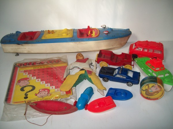 TOYS: TOYS INCLUDING GESS-A-PEG; DOLL; BOATS; CARS. USED CONDITION; CRACK; STAINS. LARGEST MEASURES 20 1/2 INCHES LONG. ALL SALES ARE FINAL, ITEMS ARE SOLD "AS IS". FOR COMPLETE CONDITION REPORT CONTACT AUC