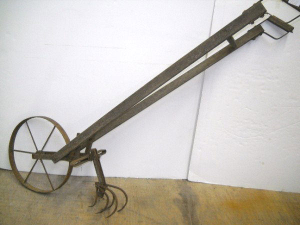 FARM TOOL: LARGE FARM TOOL- WALK BEHIND PLOW. RUSET; WEAR; HANDLES SEPERATED. 42 INCHES HIGH X 22 INCHES WIDEALL SALES ARE FINAL, ITEMS ARE SOLD "AS IS". FOR COMPLETE CONDITION REPORT CONTACT AUCTION HOUSE BY EM