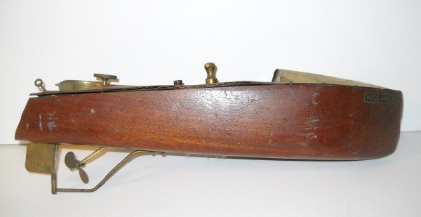 TOY MODEL: TOY MODEL WOOD BOAT WITH CLOCK WORKS NAMED "MISS AMERICA" ALSO MARKED MENGEL PLAYTHINGS. SCRATCHES; WOOD SPLIT; TOP LIFTING. 15 INCHES X 5 INCHES X 3 1/2 INCHES. All property is sold "AS IS", "WHERE I