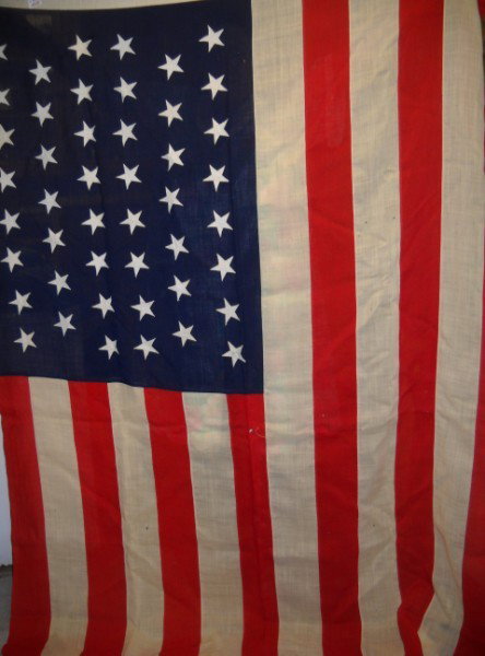 FLAG: LARGE 46 STAR FLAG, 1910. SMALL HOLES, STAIN. 5 FT. X 8 FT. All property is sold "AS IS", "WHERE IS", and ALL SALES ARE FINAL. There are NO REFUNDS, NO EXCHANGES. ALL ARTWORK, PAINTINGS, ENGRAVINGS, L