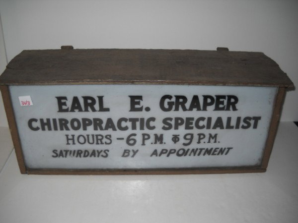 ADVERTISING SIGN: EARL E. GRAPER CHIROPRACTIC SPECIALIST ADVERTISING LIGHETED SIGN. WOOD BOX WITH GLASS FRONT. NEEDS RE-WIING. SCRATCHES; PAINT LOSS. 26 INCHES WIDE X 12 INCHES HIGH X 8 INCHES DEEP. All property is sol
