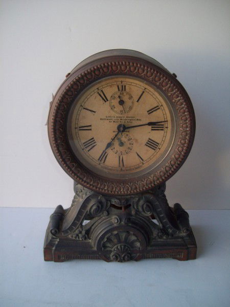 CLOCK: SETH THOMAS ADVERTISING CLOCK, FACE READS LITTLE'S JEWELRY CORNER, CORTLAND AND WASHINGTON STS. IN NEW YORK CITY. GLASS CRACKED; FOXING; METAL ON SIDE NEEDS REPAIR; PAINT LOSS; SCRATCHES. 9 INCHES X 7