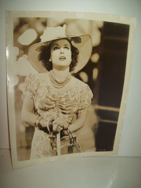 PHOTO: JOAN CRAWFORD PHOTO BY CLARENCE SINCLAIR BULL. STAMP ON BACK. STAINED. 10 INCHES X 9 INCHES. All property is sold "AS IS", "WHERE IS", and ALL SALES ARE FINAL. There are NO REFUNDS, NO EXCHANGES. ALL