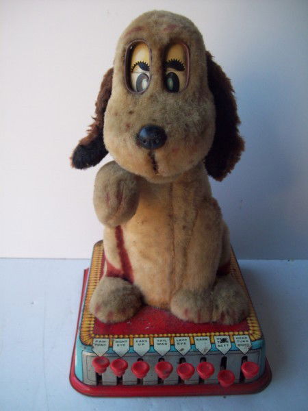 TOY: BATTERY OPERATED BUTTONS THE PUPPY WITH A BRAIN BY MARX. RUST; STAINED; LACKING TAIL; FADED; DENTS. 13 INCHES X 9 INCHES. All property is sold "AS IS", "WHERE IS", and ALL SALES ARE FINAL. There are N