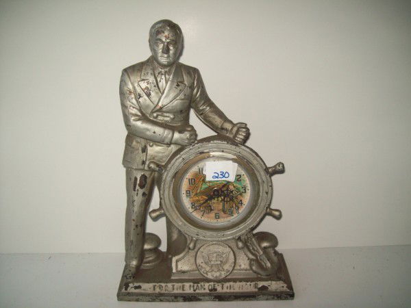 CLOCK: FDR MAN OF THE HOUR CLOCK. PAINT LOSS; SCRATCHES. 15 INCHES X 10 INCHES. All property is sold "AS IS", "WHERE IS", and ALL SALES ARE FINAL. There are NO REFUNDS, NO EXCHANGES. ALL ARTWORK, PAINTINGS,