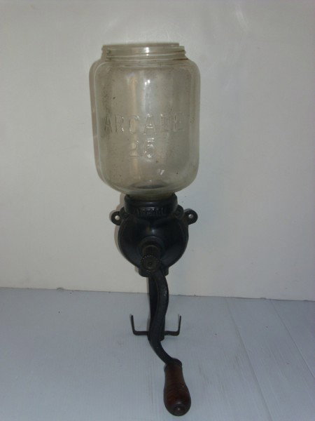 COFFEE GRINDER: ARCADE GLASS COFFEE GRINDER. LACKING PIECES. 15 1/2 INCHES HIGH X 8 1/2 INCHES WIDE. All property is sold "AS IS", "WHERE IS", and ALL SALES ARE FINAL. There are NO REFUNDS, NO EXCHANGES. ALL ARTWORK,