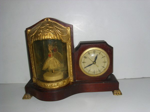 CLOCK: UNITED SELF START CLOCK WITH BALLARINA DANCING GIRL. ELECTRIC. SOME PIECES NEED RE-GLUING. USED CONDITION; SCRATCHES. 13 INCHES WIDE X 10 INCHES HIGH X 4 INCHES DEEP. PLEASE CONTACT AUCTION HALL REGAR