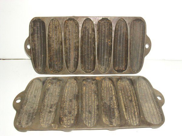 CORN MOLDS: 2 WAGNER WARE CAST IRON CORN MOLDS. 13 INCHES WIDE X 6 INCHES HIGH. USED CONDITION. PLEASE CONTACT AUCTION HALL REGARDING COMPLETE CONDITION REPORT PRIOR TO BIDDING. All property is sold "AS IS", "WHE