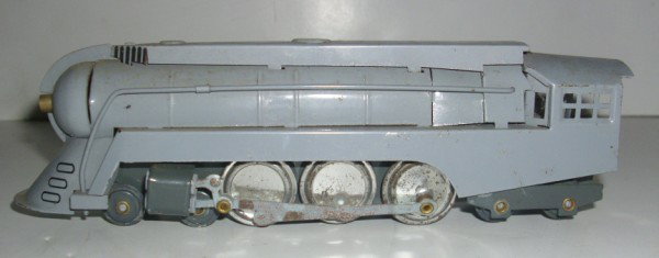 TOY: GREY METAL LOCOMOTIVE TOY TRAIN. SCRATCHES; RUST; DENT; 7 1/2 INCHES LONG X 2 1/2 INCHES HIGH. PLEASE CONTACT AUCTION HALL REGARDING COMPLETE CONDITION REPORT PRIOR TO BIDDING. All property is sold "A