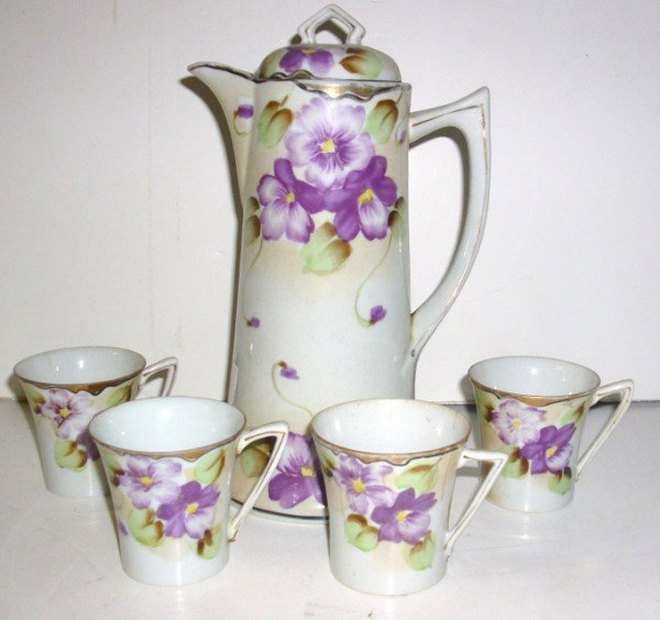 CHOCOLATE SET: HAND PAINTED NIPPON CHOCOLATE SET. CHIPS; HAIRLINE CRACKS; PAINT LOSS. CUPS NOT MARKED. 10 INCHES HIGH X 5 INCHES WIDE. All property is sold "AS IS", "WHERE IS", and ALL SALES ARE FINAL. There are NO 