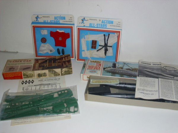 TOYS: TOY LOT INCLUDING 2 ACTION ALL STARS ACTION FIGURE CLOTHES IN BOX; AURORA SSN ATOMIC SUB SKIPJACK MODEL KIT; HAWK SAN FRANCISCO CABLE CAR. PAINT; POSSIBLE NOT COMPLETE. All property is sold "AS IS", "