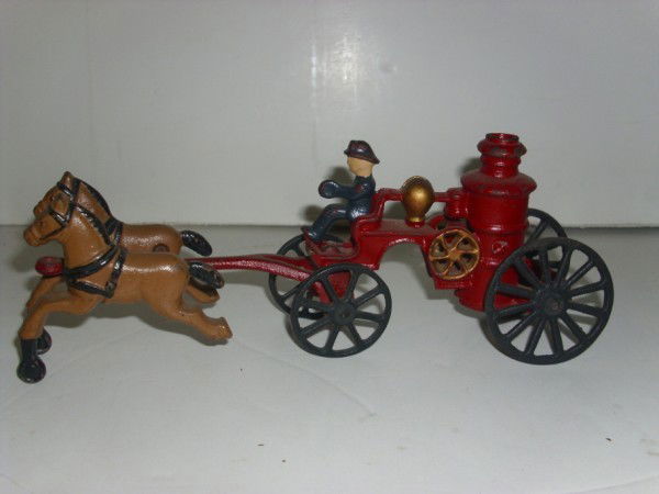 CAST IRON TOY: CAST IRON HORSE DRAWN FIRE ENGINE. PAINT LOSS; LACKING PIECES. 9 1/2 INCHES WIDE X 3 1/2 INCHES HIGH. All property is sold "AS IS", "WHERE IS", and ALL SALES ARE FINAL. There are NO REFUNDS, NO EXCHAN