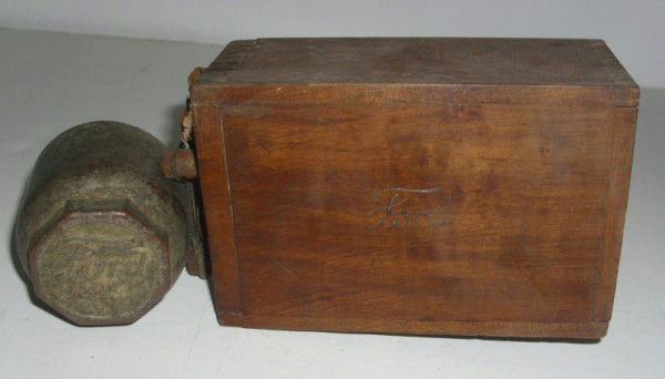 FORD CAR ITEMS: 2 PIECE FORD CAR ITEMS INCLUDING FORD MODEL T DOVETAILED WOOD BOX COIL IGNITION; TIRE CENTER CAP. USED CONDITION. 5 INCHES WIDE X 3 1/2 INCHES HIGH. All property is sold "AS IS", "WHERE IS", and ALL S